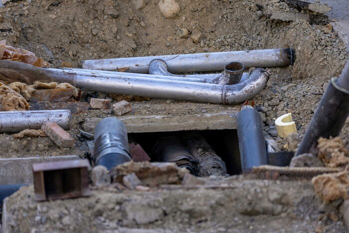 Construction site with exposed pipes and dirt, relating to stories from folks who quit their jobs in record time.