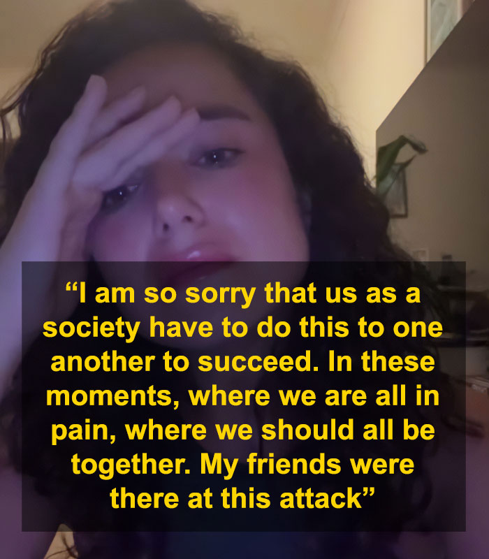 Young woman with curly hair holding her head, expressing distress after Bondi Beach attack controversy involving swimwear model.