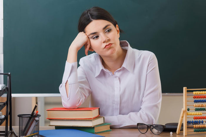 Young woman looking concerned and uncomfortable at office desk, suspecting inappropriate intentions from colleague. Young woman looking concerned and uncomfortable at office desk, suspecting inappropriate intentions from colleague.