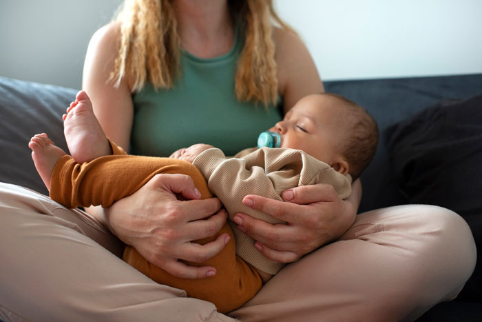 Woman gently holding her granddaughter, illustrating a moment related to refuse taking care granddaughter free concerns.