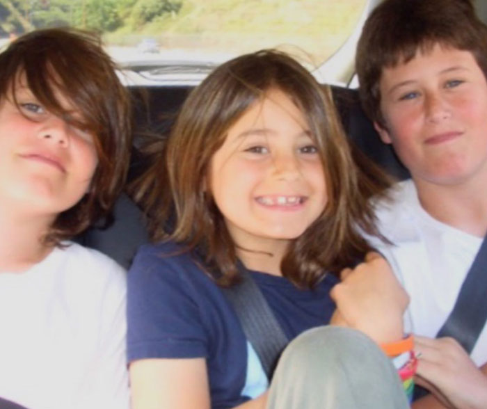 Three children of Rob Reiner sitting together in a car, smiling and wearing casual clothing. Three children of Rob Reiner sitting together in a car, smiling and wearing casual clothing.