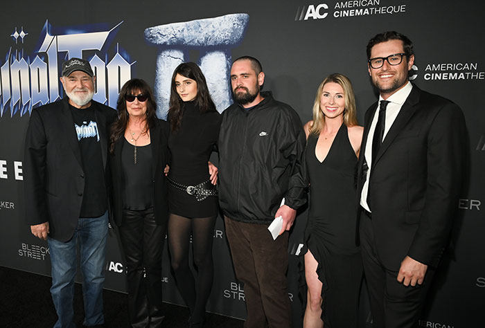 Group of six adults posing at an event, son eyed as person of interest after Rob Reiner and wife found slain in LA home