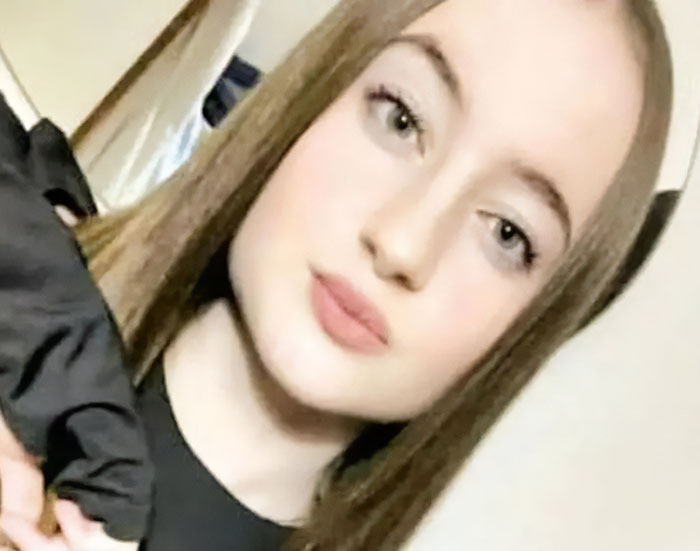 Young woman with long hair in a black top, related to story about Italian mother and daughter fatal Christmas dinner alert.