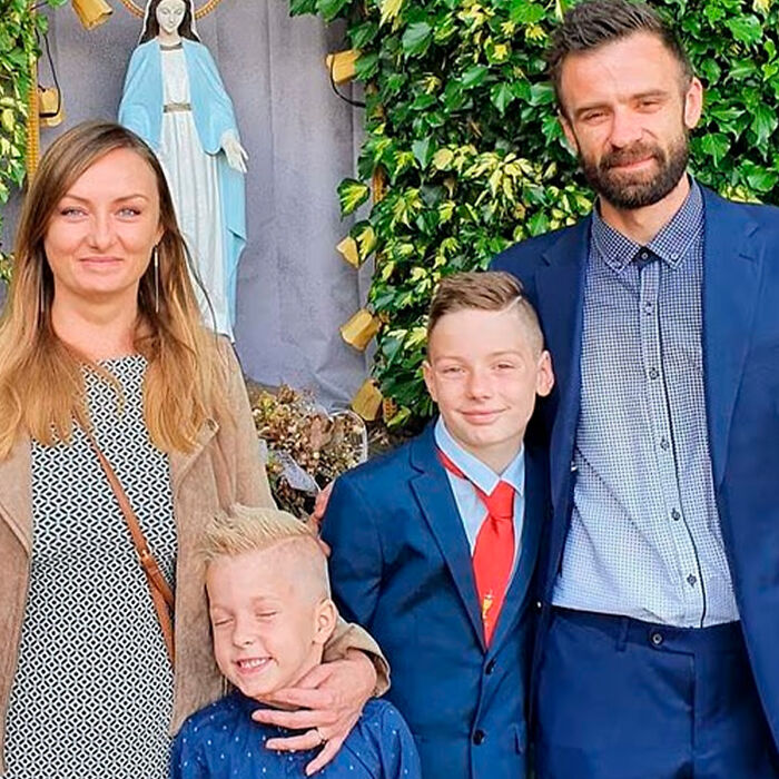 Family of schoolboy, 12, posing outdoors near religious statue as investigation reveals details of Squid Game prank incident.