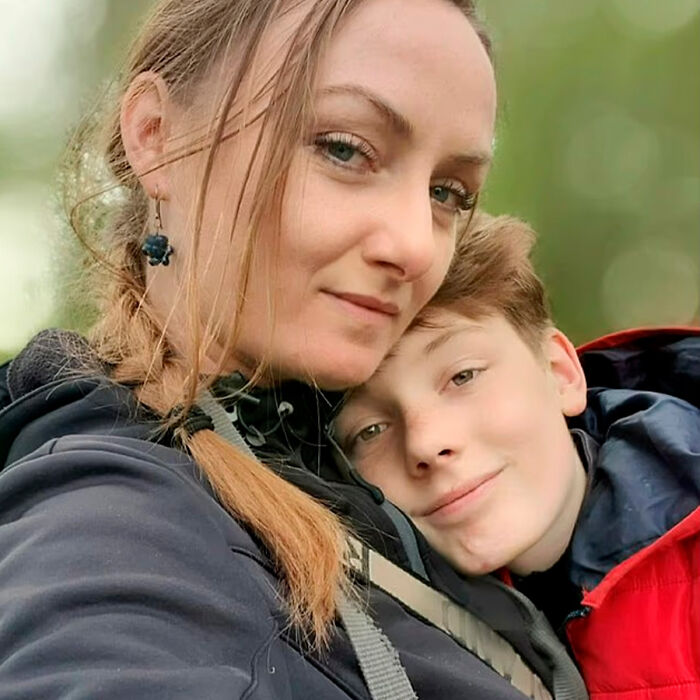 Woman and schoolboy, 12, hugging outdoors with green background, related to investigation about Squid Game prank incident.