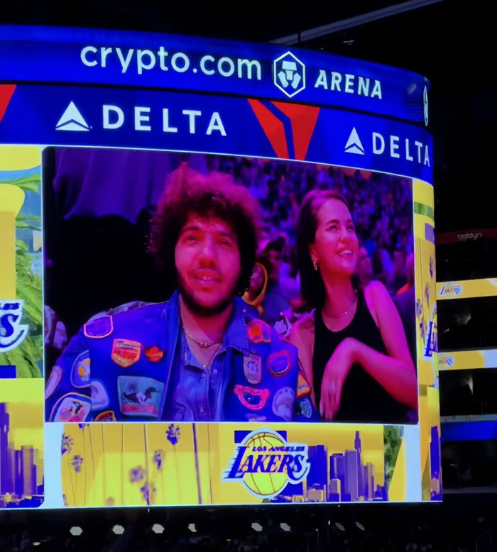 Benny Blanco and Selena Gomez shown on a stadium screen during a Los Angeles Lakers basketball game. Benny Blanco and Selena Gomez shown on a stadium screen during a Los Angeles Lakers basketball game.