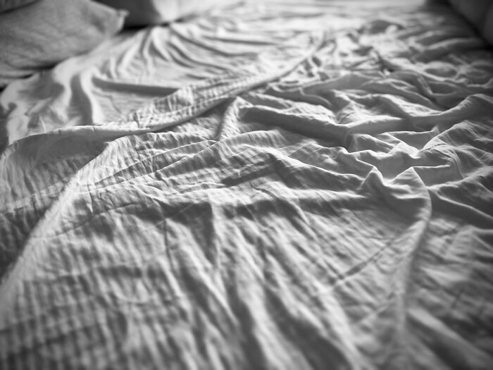 Wrinkled and messy bedsheets on an unmade bed, illustrating everyday things people accidentally did wrong.