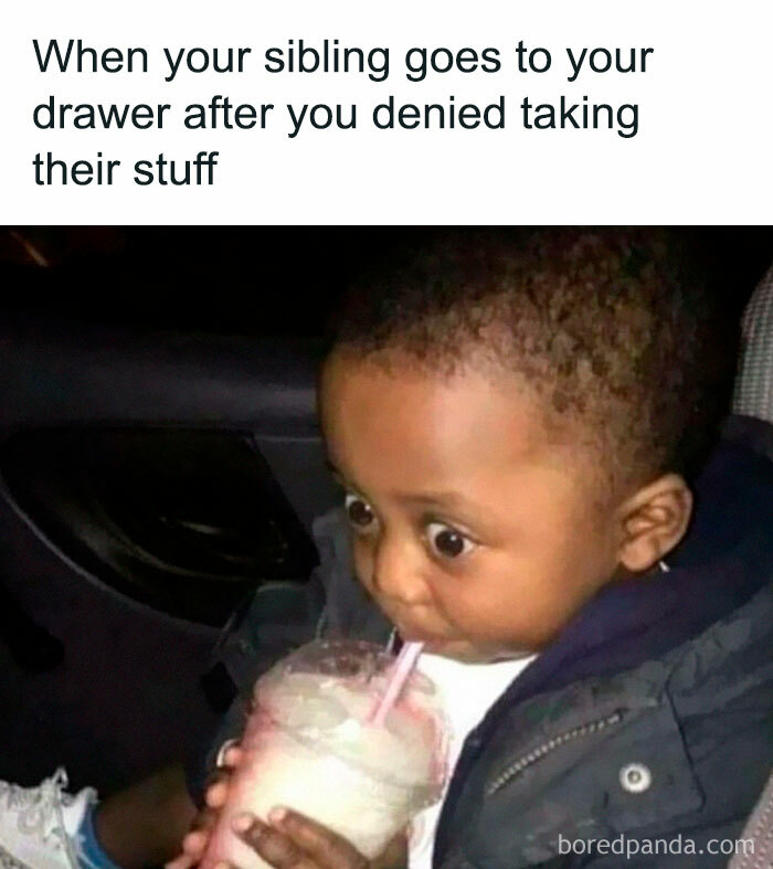 Child sipping a drink with wide eyes, illustrating the humor of sibling relationships in memes about having siblings.
