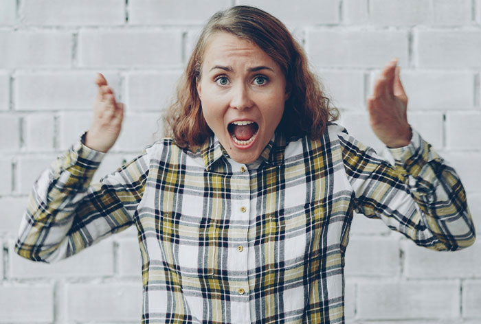 Angry woman expressing frustration and shocked by entitled behavior while trying to help her brother and his wife. Angry woman expressing frustration and shocked by entitled behavior while trying to help her brother and his wife.