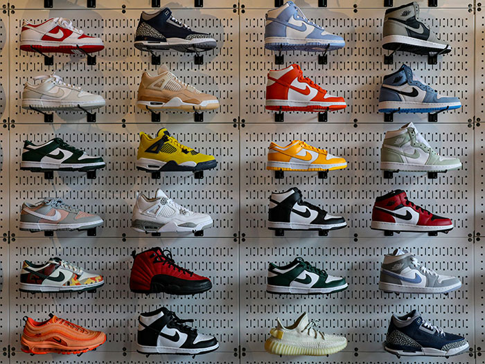 Various sneakers displayed on a wall, showcasing bold and clever designs that outsmart typical footwear styles.