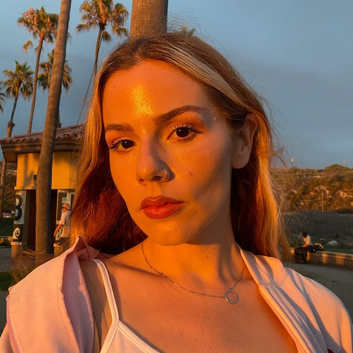 Young woman posing outdoors at sunset, a woke social media user featured in decolonized Christmas discussion. Young woman posing outdoors at sunset, a woke social media user featured in decolonized Christmas discussion.