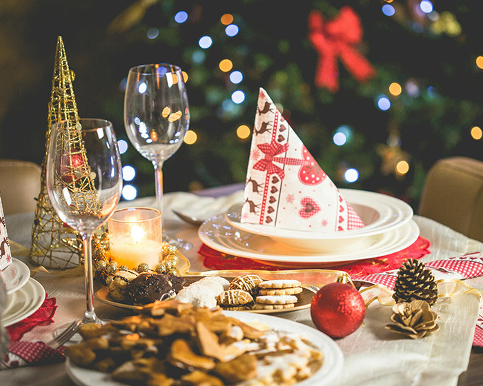 Festive holiday table setting with Christmas decorations and desserts in a scene related to decolonized Christmas. Festive holiday table setting with Christmas decorations and desserts in a scene related to decolonized Christmas.