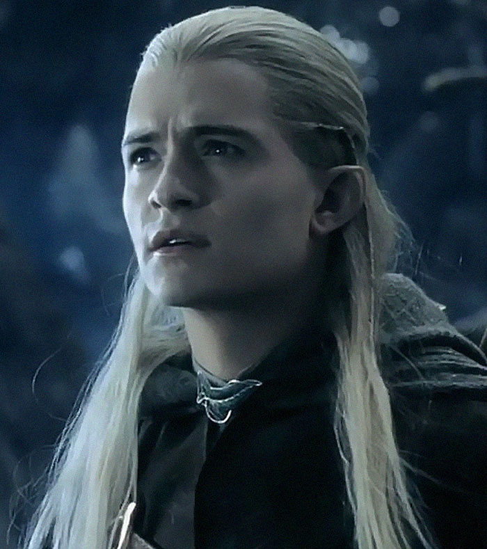 Elf with long blonde hair showing panic on his face in a serious moment from a fantasy setting.