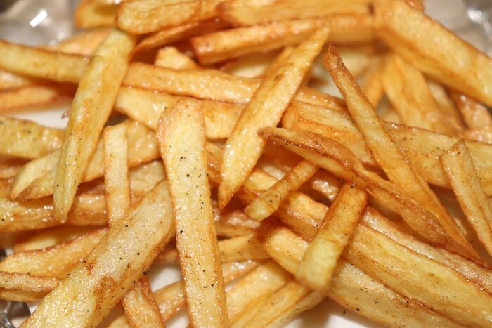 Close-up of crispy fried French fries highlighting everyday things more dangerous for your health than you realize.
