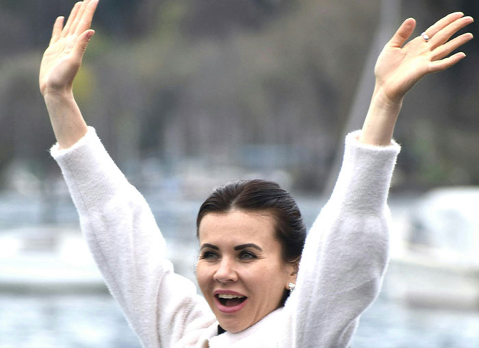 Woman outdoors raising arms, illustrating mammalian dive reflex related to surprising human body facts.
