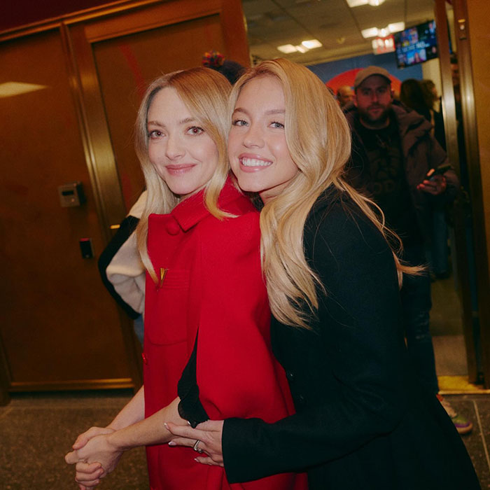 Sydney Sweeney and Amanda Seyfried smiling and posing together in a candid moment sparking media bias and racial double standards debate