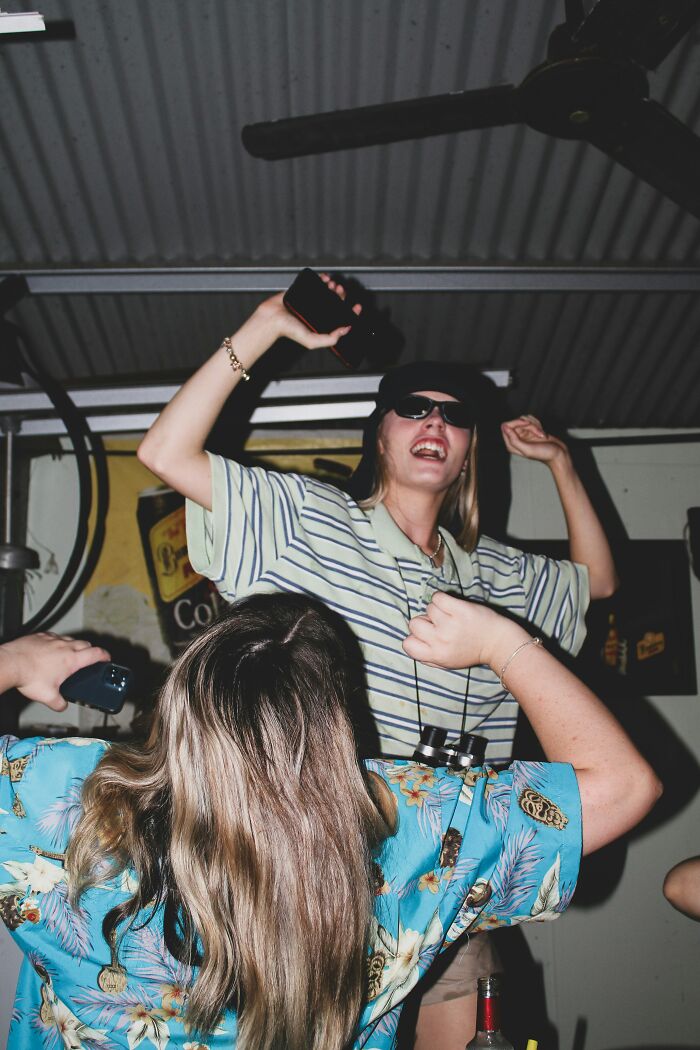 Two friends dancing and having fun indoors, highlighting chaotic best friend moments and close friendships.