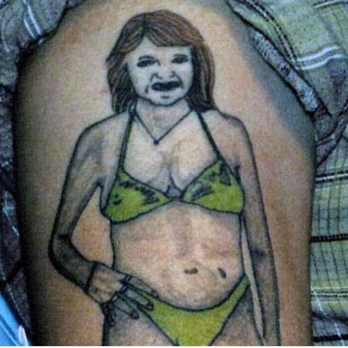 Tattoo of a woman in a green bikini with distorted features, showcased in a group dedicated to the worst tattoos out there.