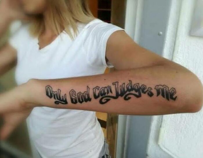 Person showing a tattoo with misspelled lettering on the forearm, part of worst tattoos shared in an online group.