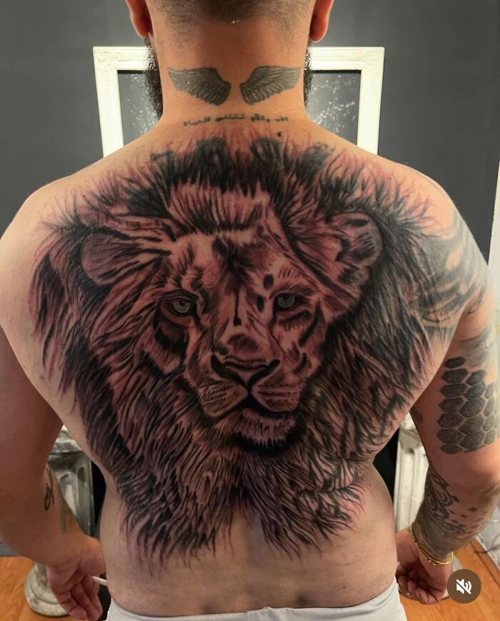 Large lion tattoo covering a man’s back, featured in an online group dedicated to the worst tattoos causing members to cringe.