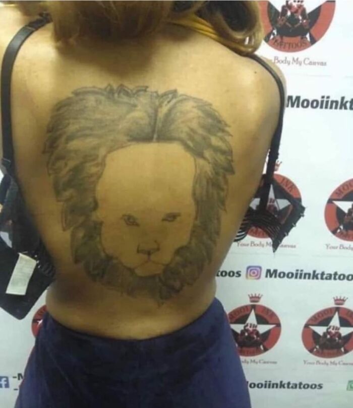 Tattoo of a poorly executed lion on a person's back, featured in a group dedicated to the worst tattoos out there.