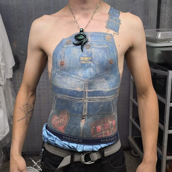 Man with a tattoo of denim overalls covering his torso, showcasing a unique example of worst tattoos in an online group.