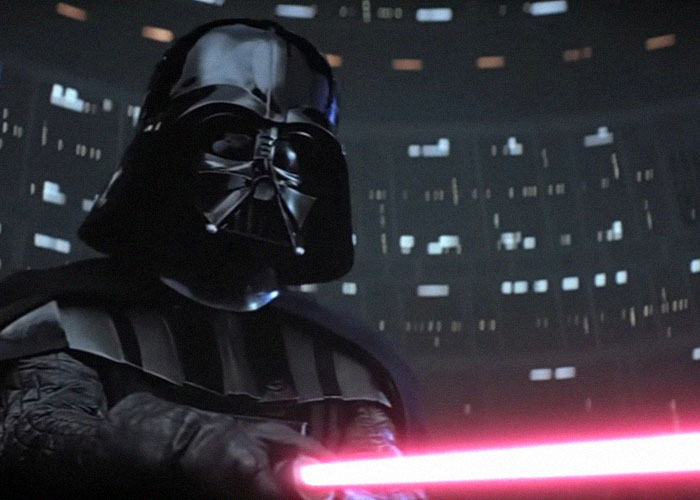 Darth Vader holding a red lightsaber inside a dark room with illuminated windows, representing interesting today I learned facts.