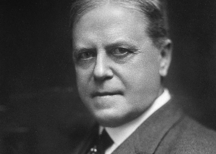 Black and white portrait of a serious man in a suit, illustrating interesting today I learned facts for readers tired of the news.