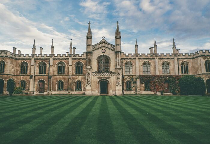 Historic stone building with spires overlooking a large green lawn, illustrating facts that sound made up but are true.