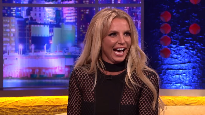 Celebrity woman with long blonde hair smiling during a colorful TV show interview about people who think celebrities suffer.