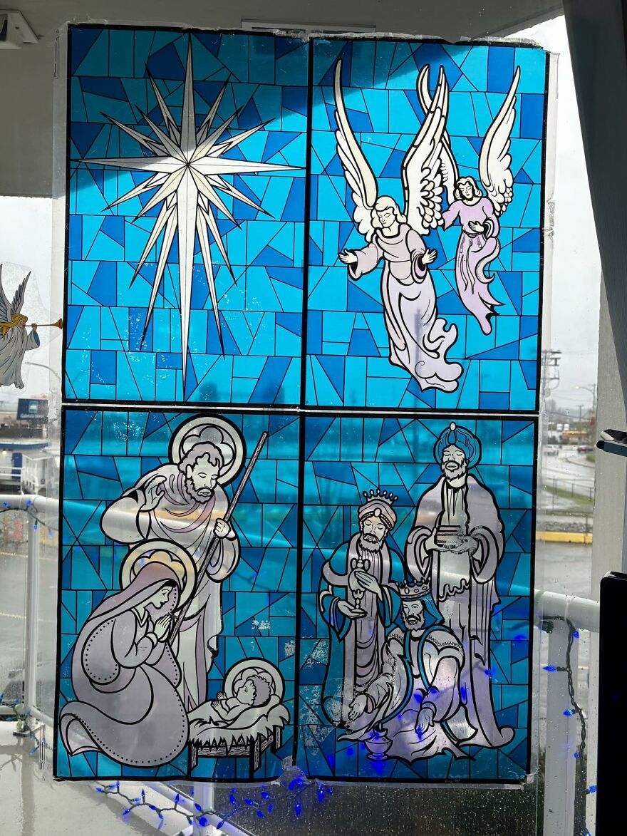 Stained glass vintage Christmas decoration depicting nativity scene with angels, star, and wise men in blue tones.