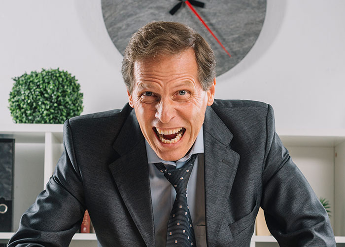 Man in a suit with a wild expression, illustrating unexpected cause-and-effect moments in a professional setting.