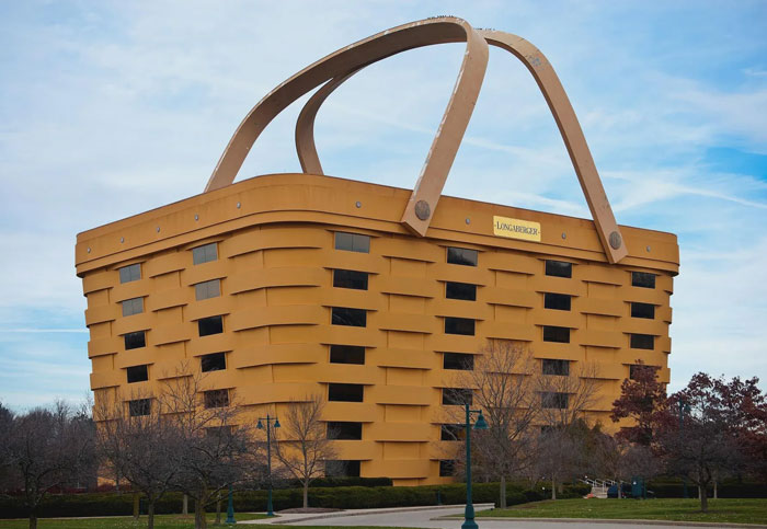 Building shaped like a giant woven bread basket with large handles, known as Bread-Shaped Bread Factory architecture.