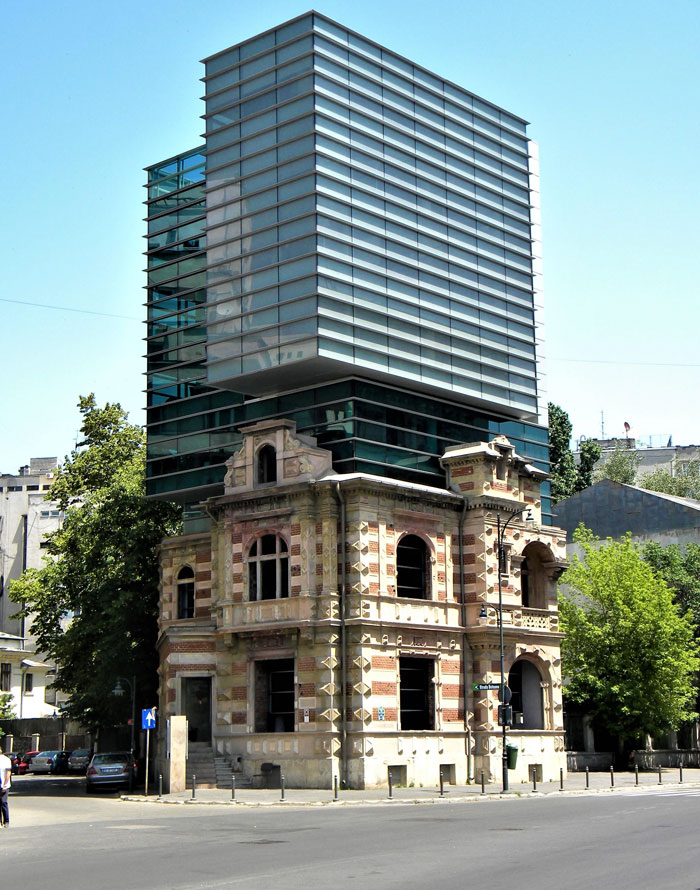 Historic building merged with modern glass structure above, showcasing unique architecture among weirdest buildings worldwide.
