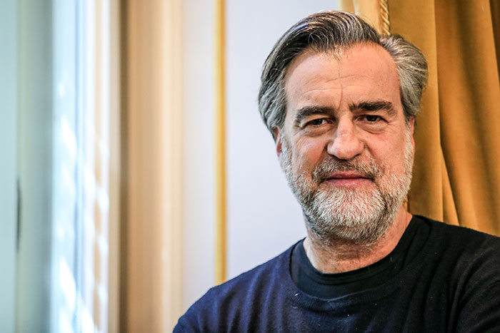 Middle-aged man with gray hair and beard, wearing a dark sweater, representing DNA tests revealing shocking family information.