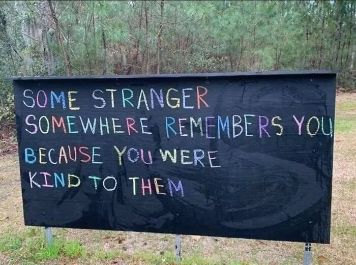Colorful chalk message on a blackboard in a forest expressing kindness, perfect sweet and wholesome pics to cleanse your feed.