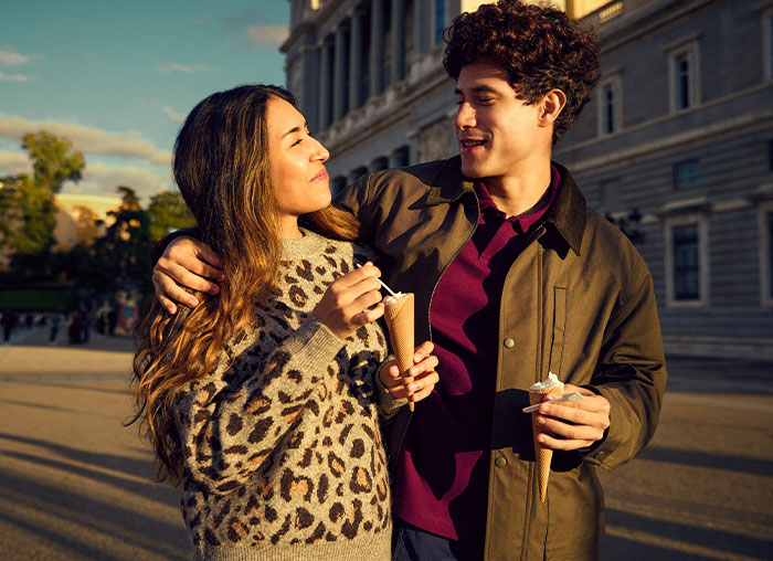 Young couple enjoying ice cream outdoors, illustrating a daughter treating boyfriend like a personal ATM concept. Young couple enjoying ice cream outdoors, illustrating a daughter treating boyfriend like a personal ATM concept.