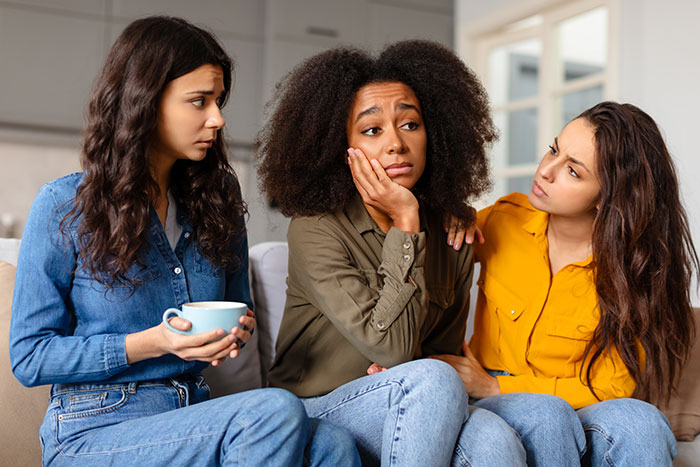 Three women on a couch, mentally unstable woman accused of trying to put gas in bestie's drink, friends looking concerned Three women on a couch, mentally unstable woman accused of trying to put gas in bestie's drink, friends looking concerned