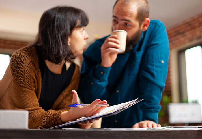 Woman and man having a serious conversation, reflecting on regret and reality check after divorce decision.