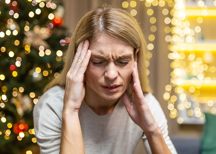 Stressed mom holding her head during Christmas, overwhelmed by running away from her 3 kids and a wake-up call.