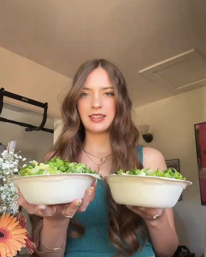Young woman holding two Chipotle bowls comparing food portions to test order differences under male names
