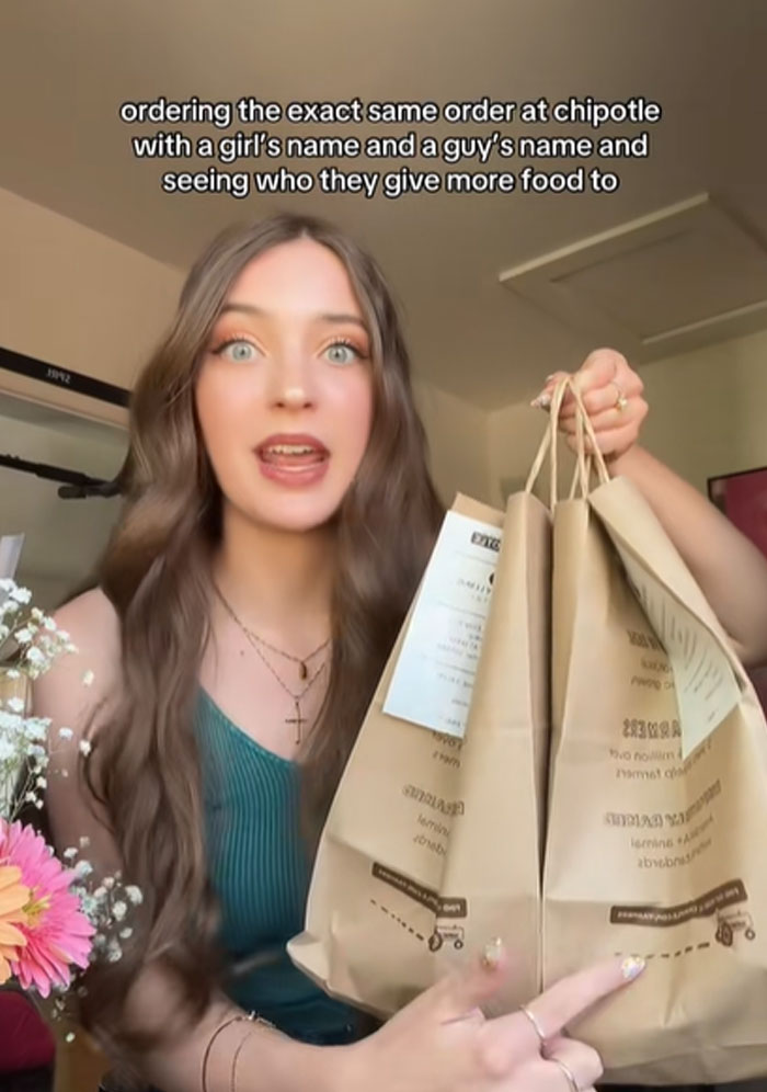 Woman holding multiple Chipotle bags testing if orders with male names get more food than female names