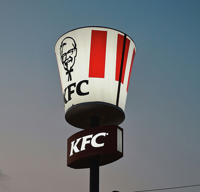 KFC restaurant sign shaped like a bucket at dusk, representing a brand mistake that caused customer boycott.