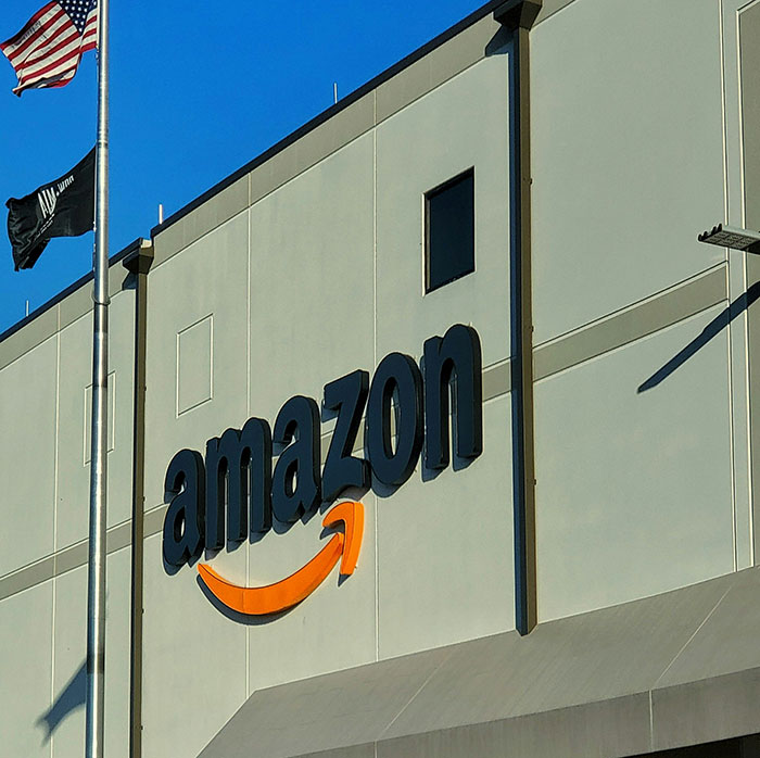 Amazon logo on a building exterior with flags nearby, illustrating a brand mistake that led to consumer boycott.