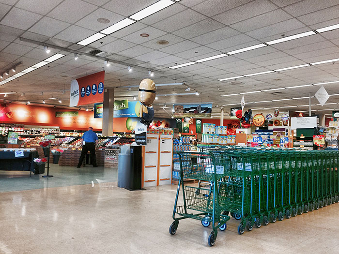 Grocery store interior with empty shopping carts, highlighting brand mistakes that led to customer boycotts.