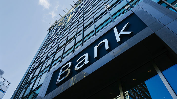 Modern glass bank building exterior with brand signage, representing brand mistakes that led to consumer boycott controversies.