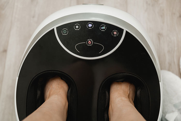 Feet inside a black and white foot massager, illustrating one of the worst gifts people have ever received.