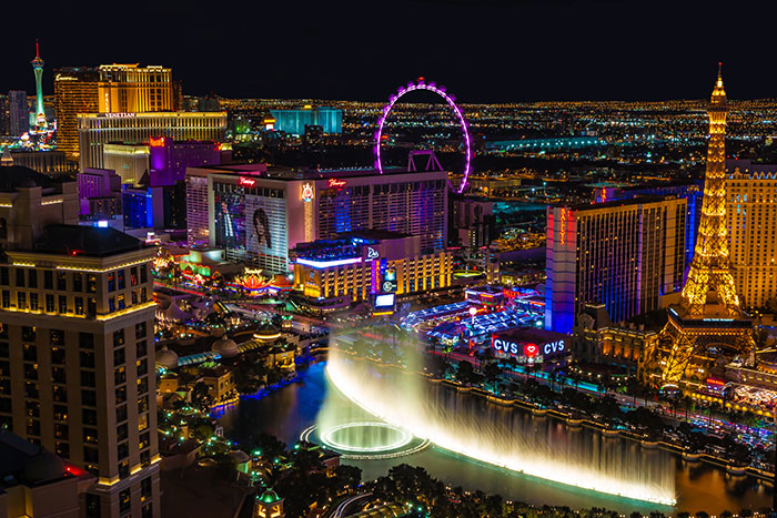 Night view of Las Vegas Strip with fountains and lights, illustrating the worst proposal stories location.