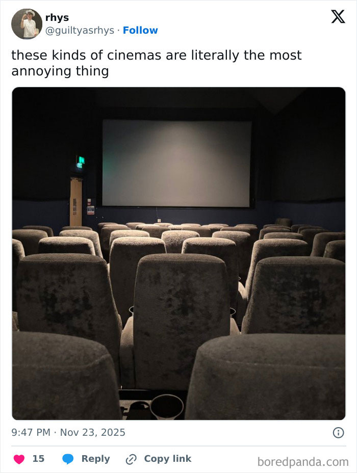 Small, dim movie theater with worn gray seats facing a blank screen, illustrating worst movie theaters experience.