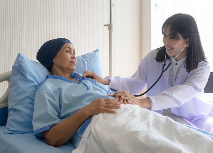 Doctor using stethoscope to check a patient in hospital bed, illustrating worst things patients endured per hospital workers.